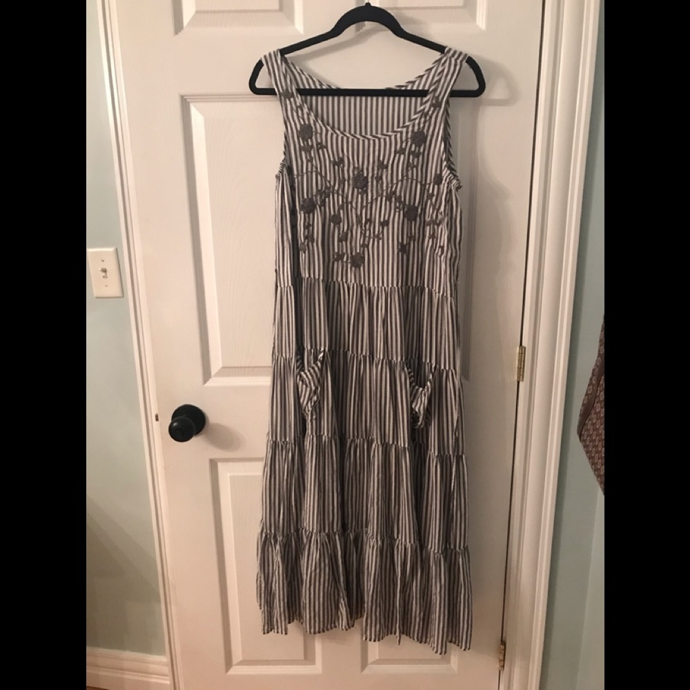 Grey and white striped tiered dress with embroidered flowers.
